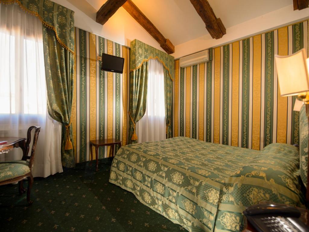 Postel nebo postele na pokoji v ubytování Centauro Hotel