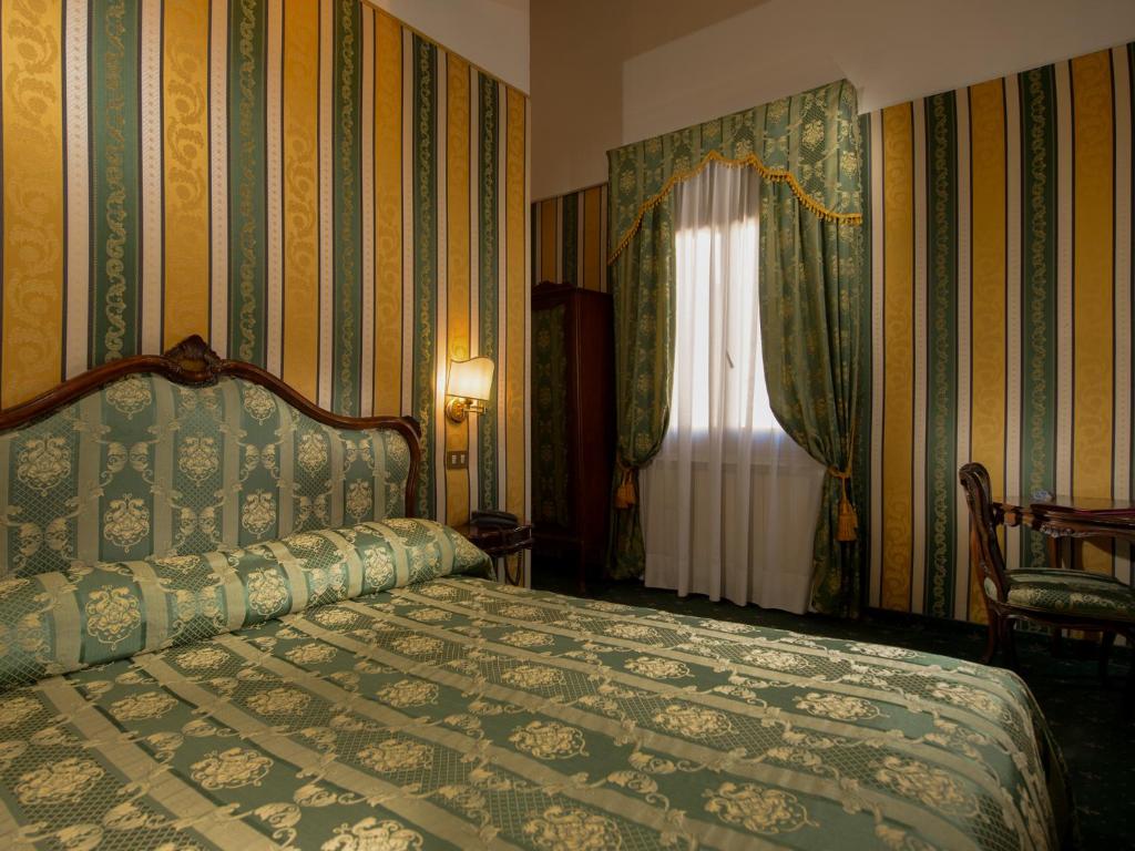 Postel nebo postele na pokoji v ubytování Centauro Hotel