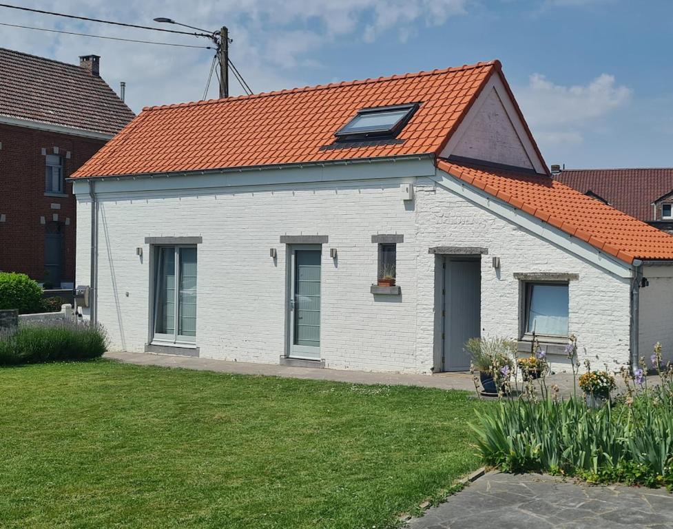 a white building with an orange roof at Les Limousines - Proche de Pairi Daiza, Mons, Soignies in Soignies