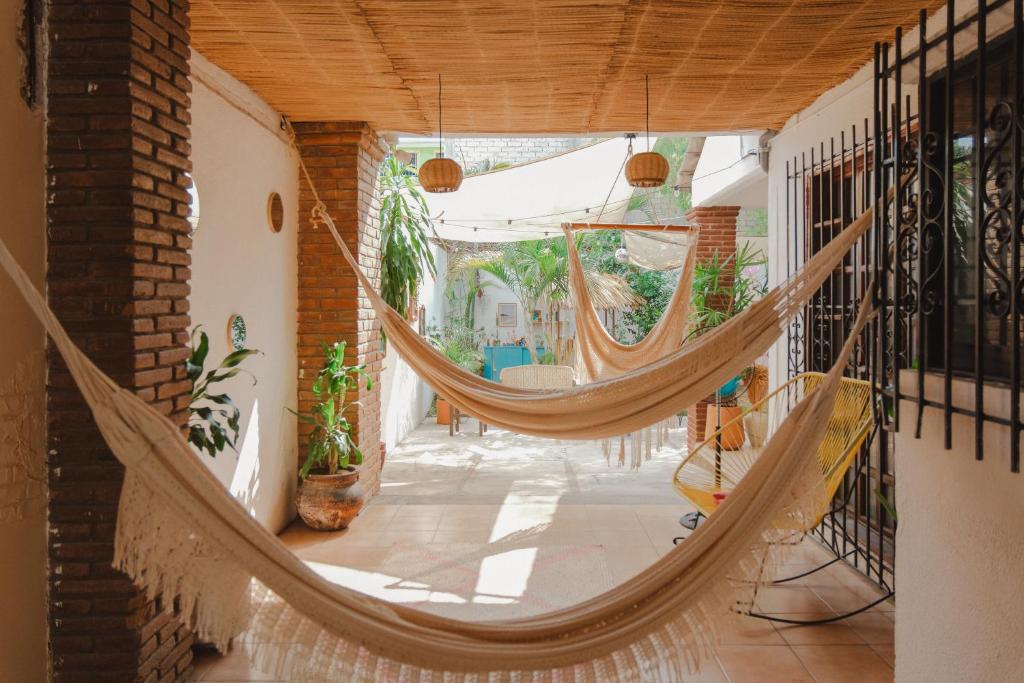 a hammock in the hallway of a house at Casa de Rosa in Puerto Escondido