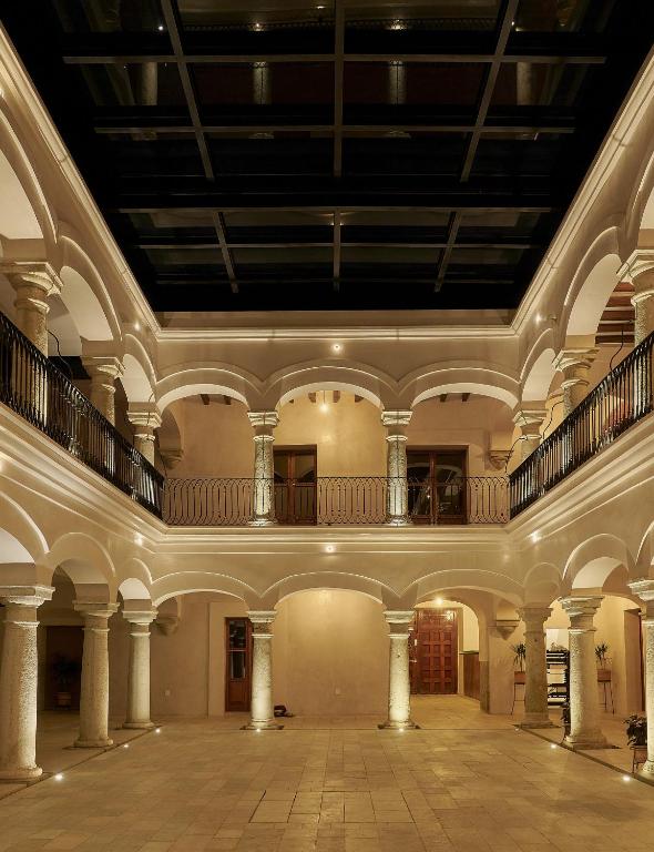 an empty room with a large ceiling and columns at Casa Quiote Hotel Boutique City Center based - Adults Only in Oaxaca City