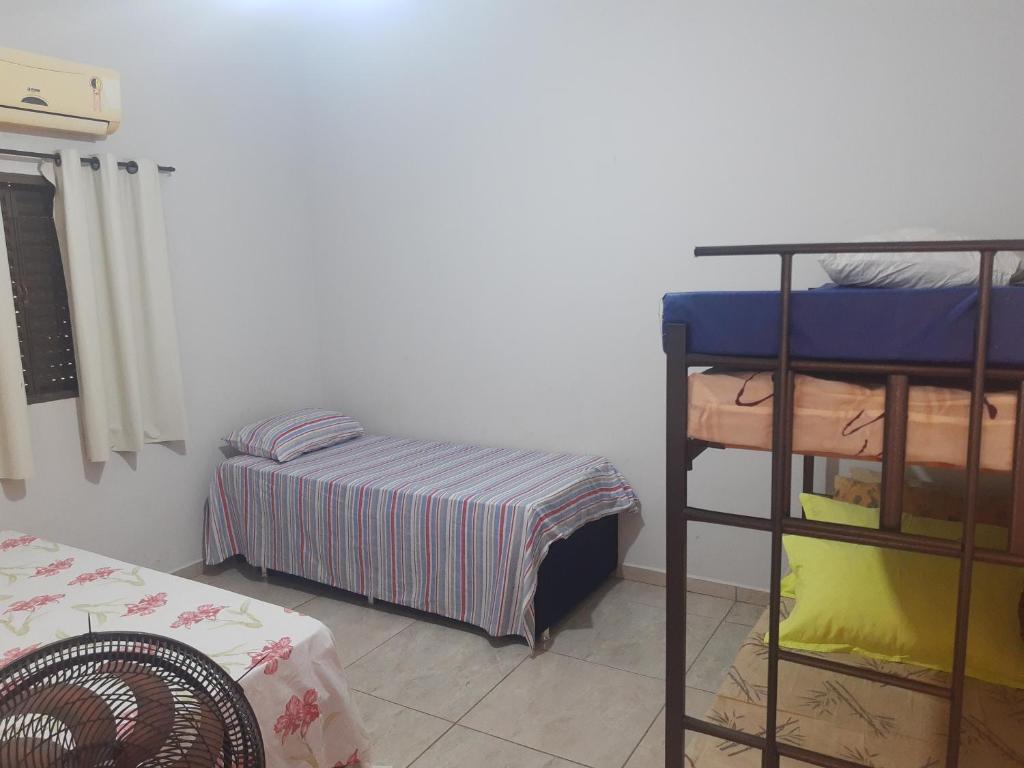 a room with two bunk beds and a bed at quiet corner in Sao Jose do Rio Preto
