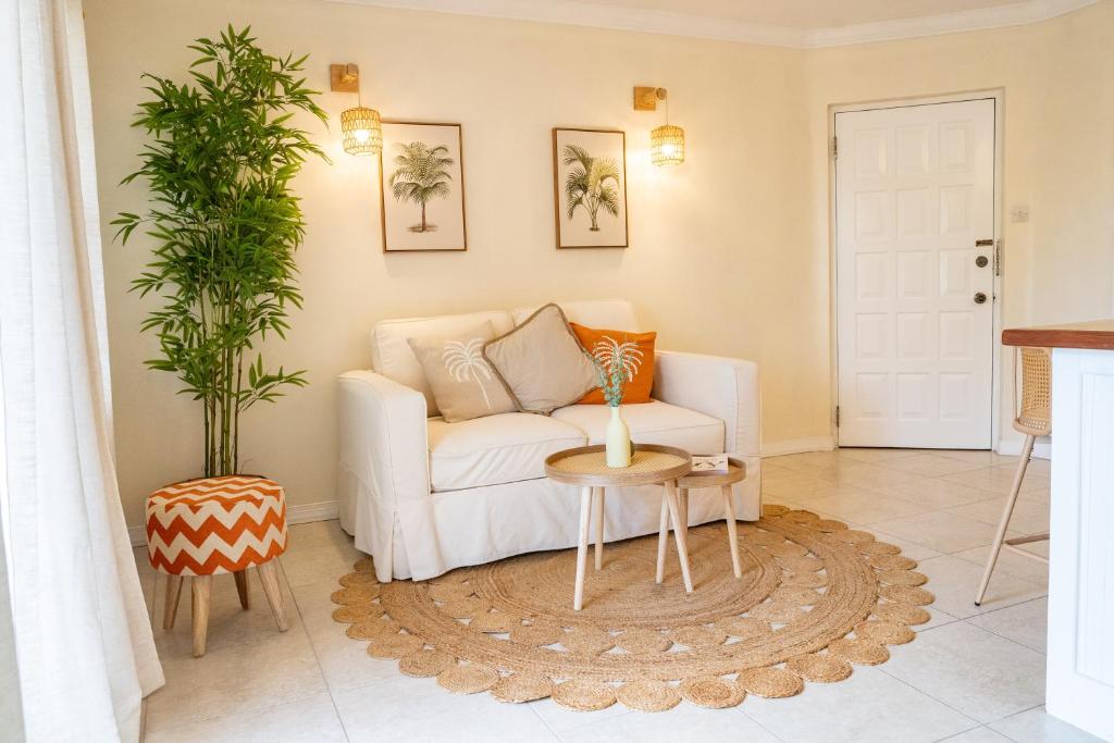 a living room with a white couch and a table at Golden View Unit 204 in Saint James