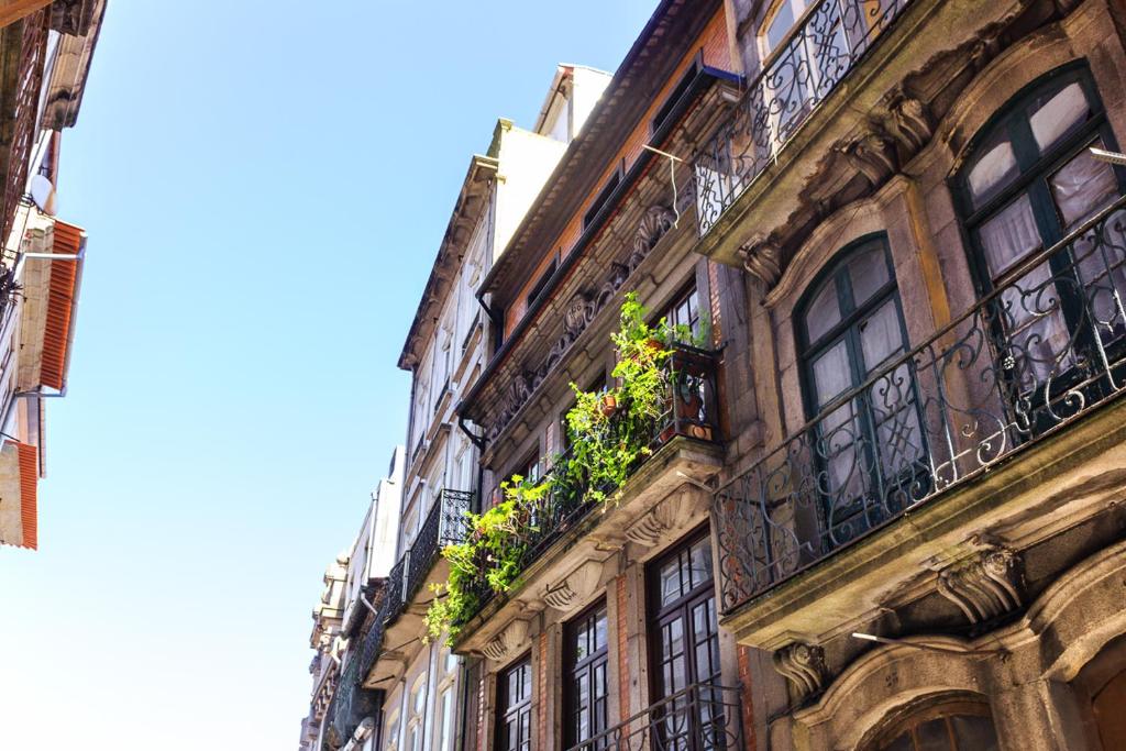 a building with balconies and plants on the side of it at Chateau Belomonte in Porto