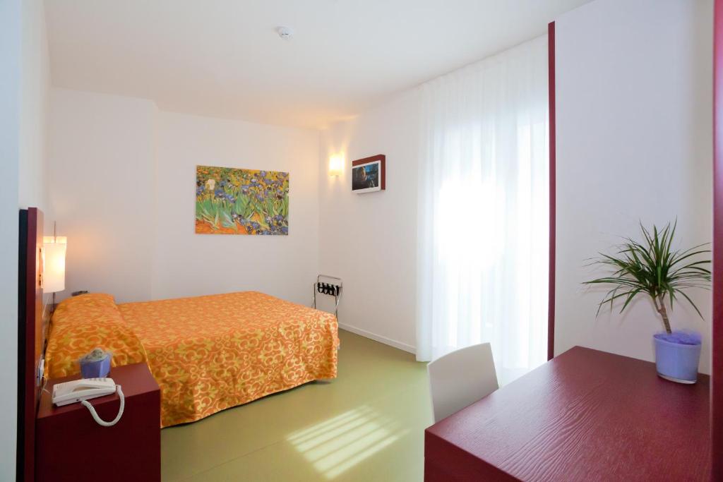 Postel nebo postele na pokoji v ubytování Hotel Raffaello