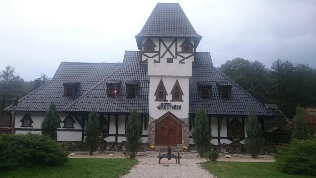 un gran edificio blanco con una torre de reloj en Royal Village Kotromanićevo, en Vranduk