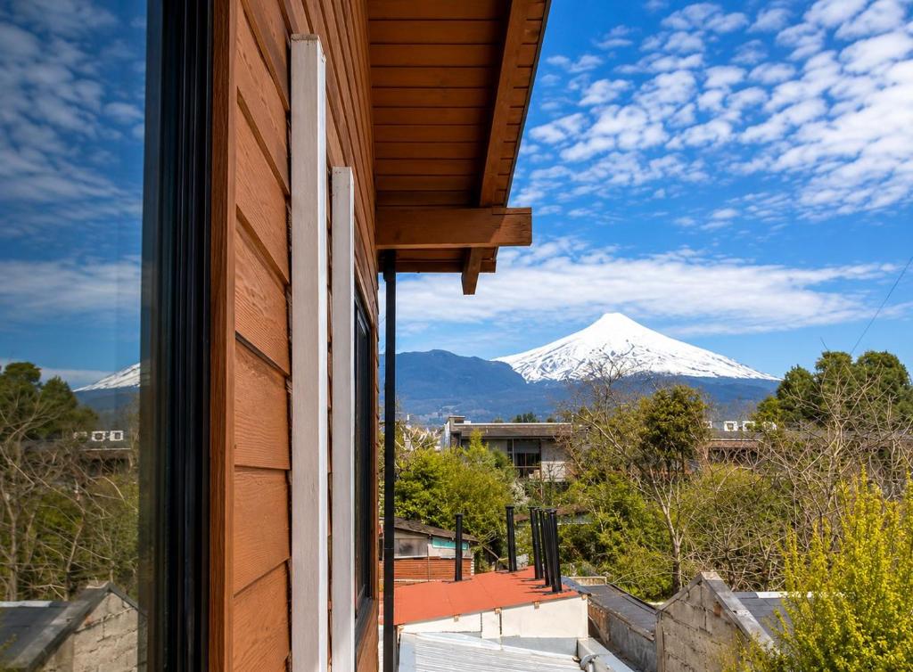 a view of a snow covered mountain from a window at Hotel El Coihue in Pucón