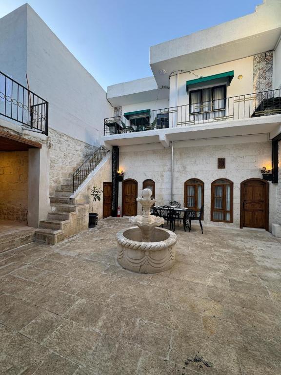 a courtyard with a fountain in the middle of a building at Antikhan Han Yusufpaşa in Urfa