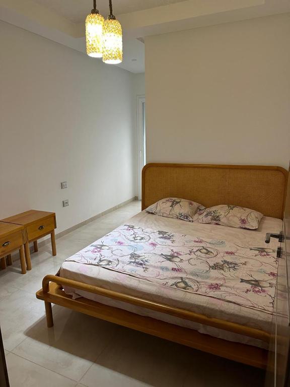a bed in a white room with a bed sidx sidx sidx at Zaineb in Hammamet Sud