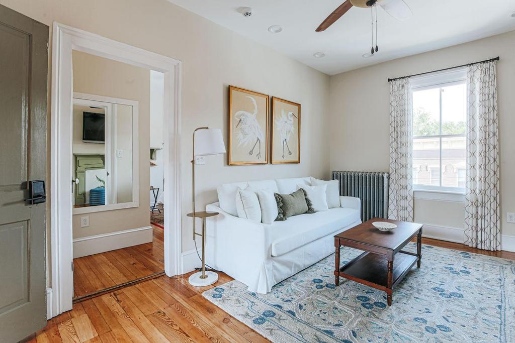 a living room with a white couch and a table at Red Bud Suite in Staunton