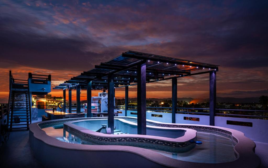 a swimming pool on top of a building with a sunset at Casa Del Toro in Barra de Navidad