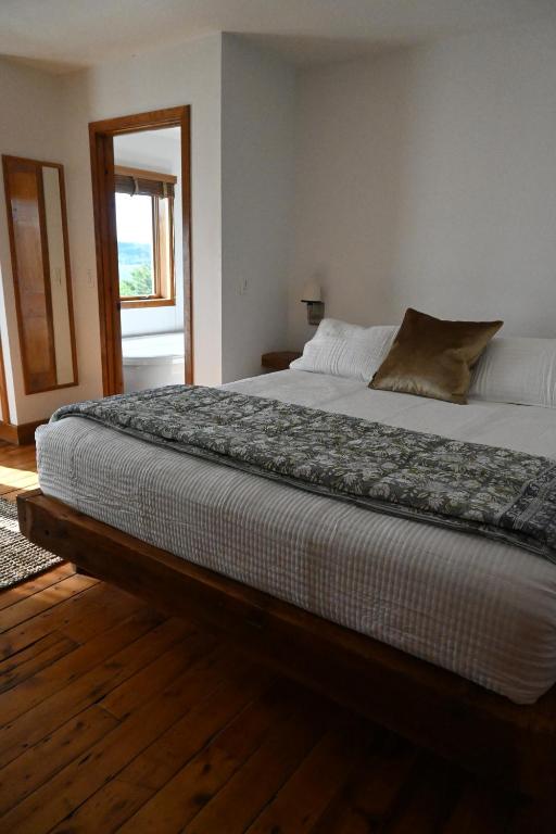 a large bed in a bedroom with a window at Rhinecliff Hotel in Rhinecliff