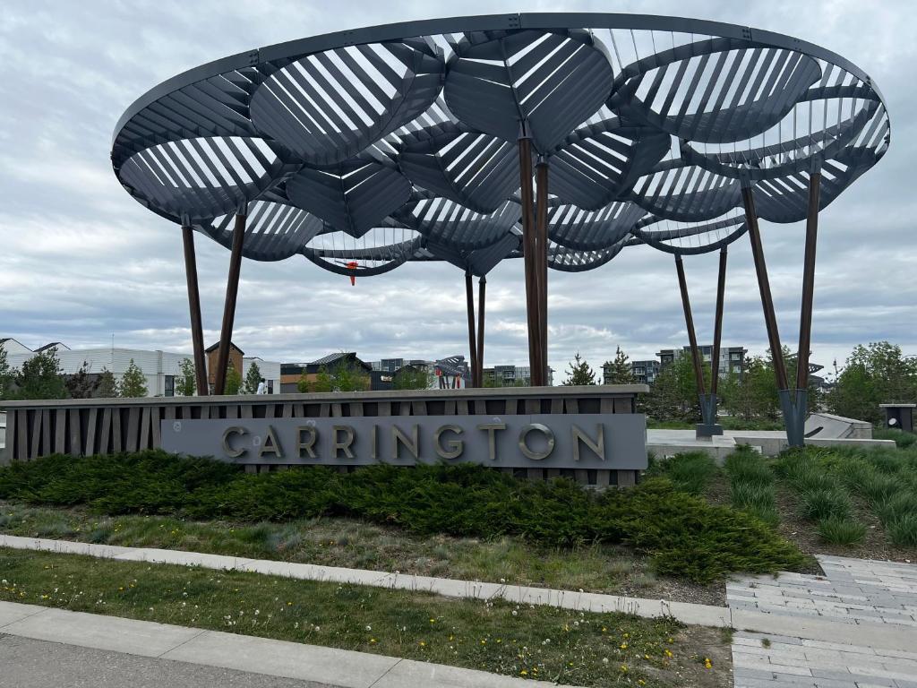 a metal sculpture of three umbrellas on top of a sign at Cozy private basement suite with separate entrance in Calgary
