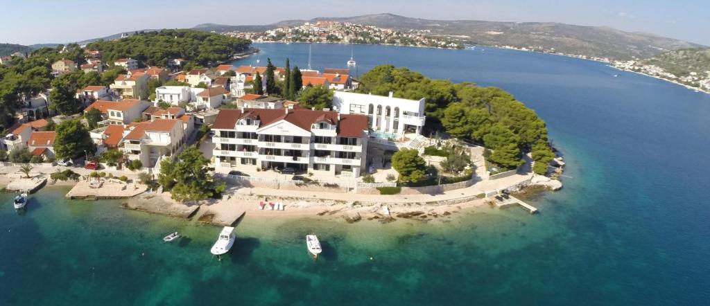 a large building on an island in the water at Villa Salvia in Rogoznica