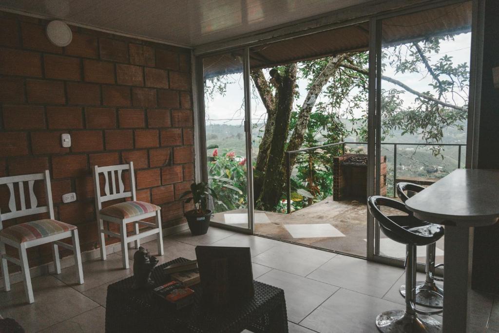 a room with two chairs and a table and a window at Tierra Mágica eje cafetero in Manizales
