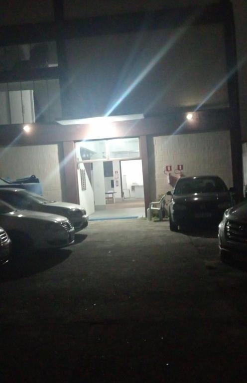 a parking lot with cars parked in a garage at Pousada Fortaleza SP 8 in São Paulo