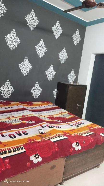a bedroom with a bed with flowers on the wall at AC Room Double Bed 1st floor House in Mohali