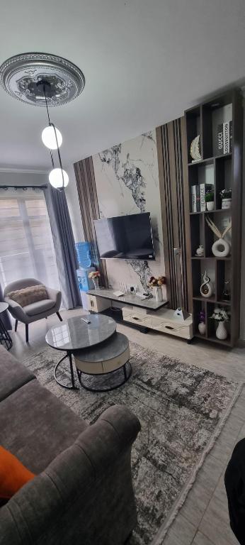 a living room with a couch and a table at Dolphin Homestays in Nairobi