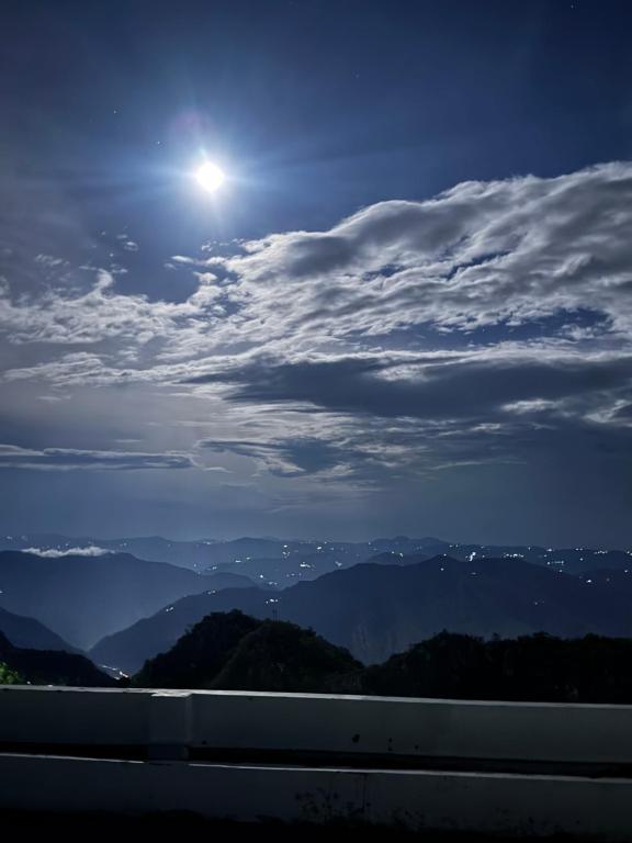a full moon over the mountains at night at Anuttara Retreat in Narendranagar