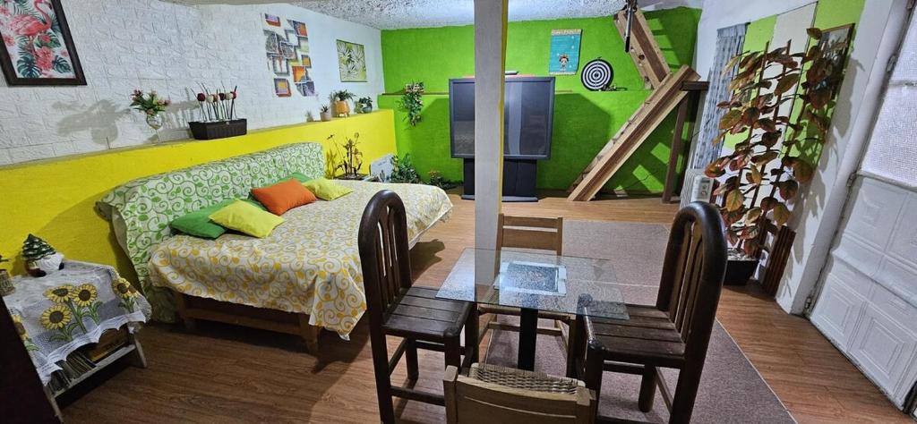 a living room with a couch and a dining room table at Casa Lulú in Mexico City