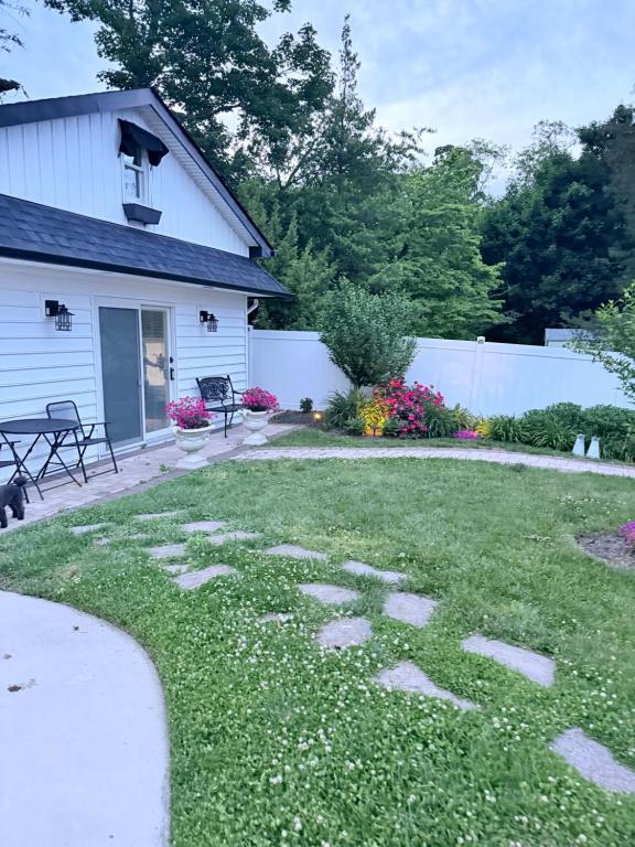 a yard with rocks in the grass at Unique guest house loft in Spring Lake