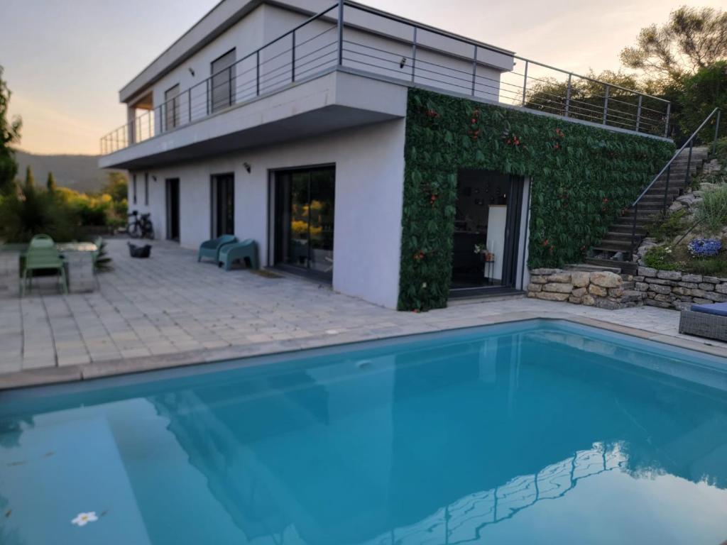 a house with a swimming pool in front of a house at TAKAMAKA in Manosque