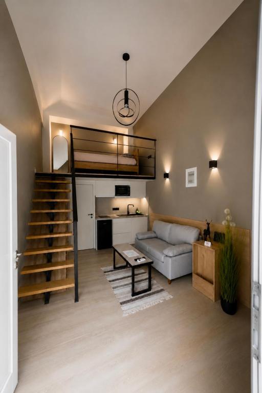a living room with a couch and a loft bed at Loft 73 in Kalamata