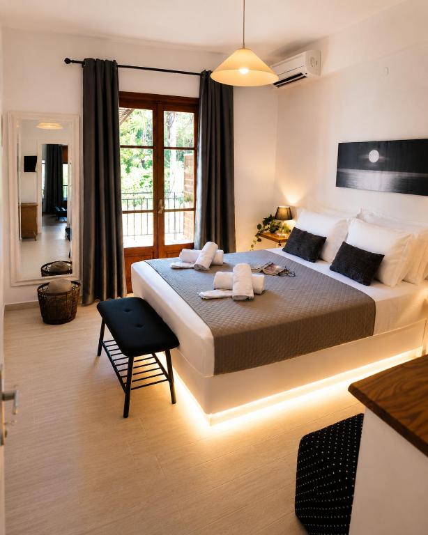 a bedroom with a large bed in a room at Efcharis house Skopelos in Neo Klima