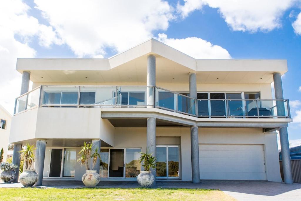 a large white house with a balcony at The Edge in Robe