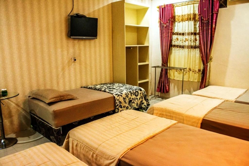 Postel nebo postele na pokoji v ubytování Hotel Alifa Syariah