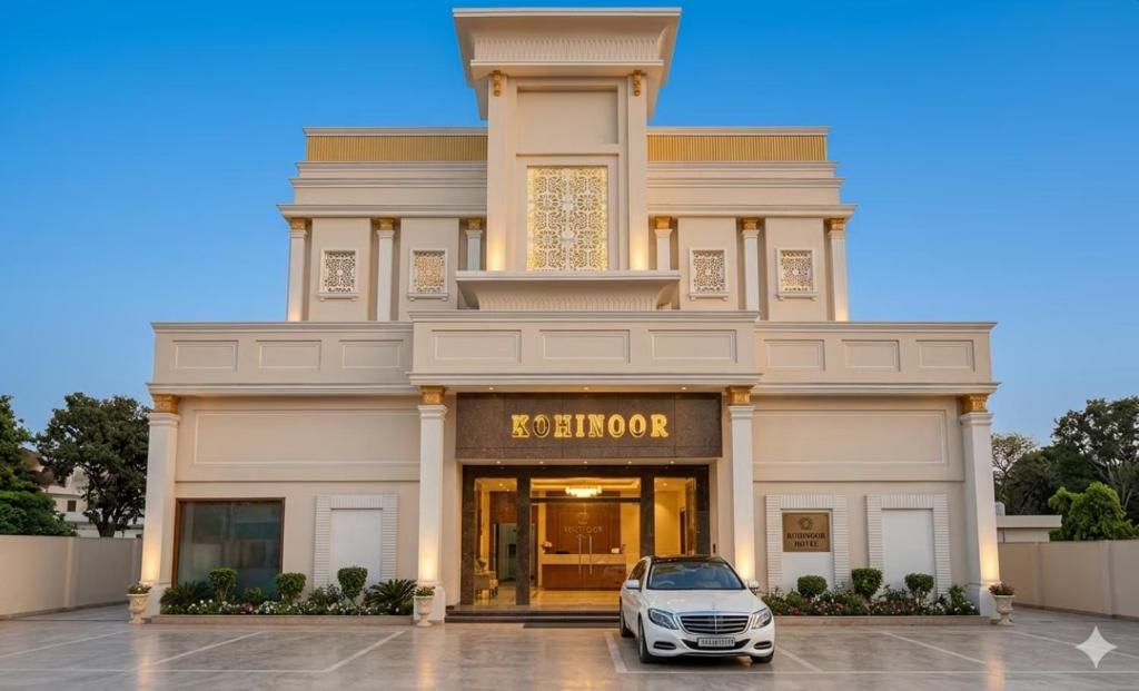 a white car parked in front of a building at Hotel Kohinoor Palace, Ludhiana in Ludhiana