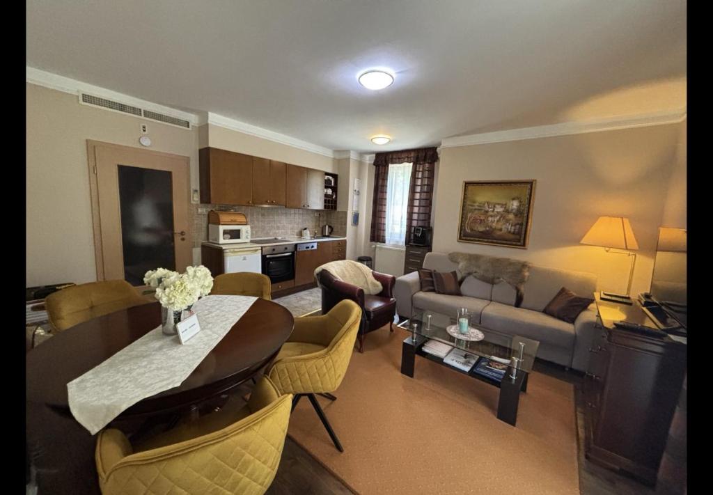 a living room with a couch and a table at Apartman Golf Lux in Bük