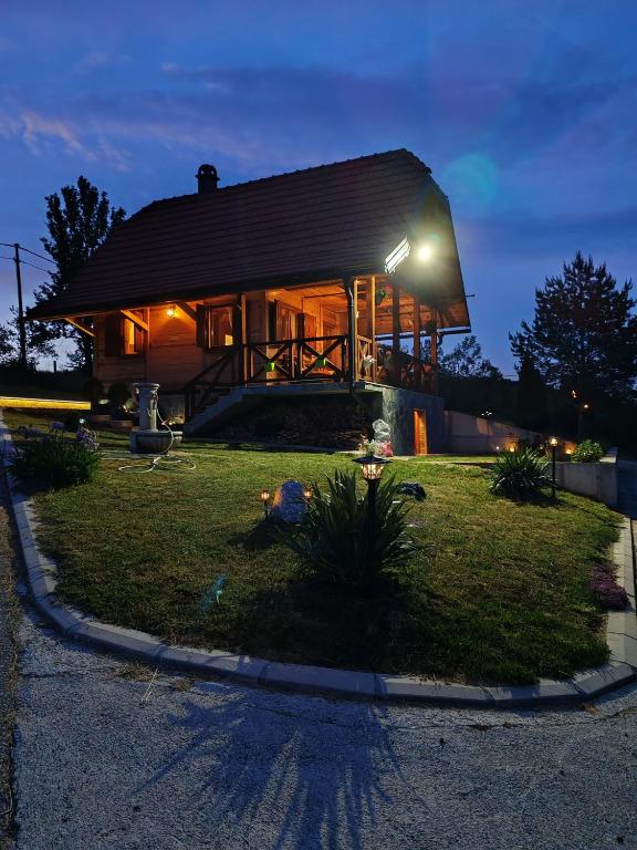 a house with a light on the front of it at Villa RESET in Zlatibor