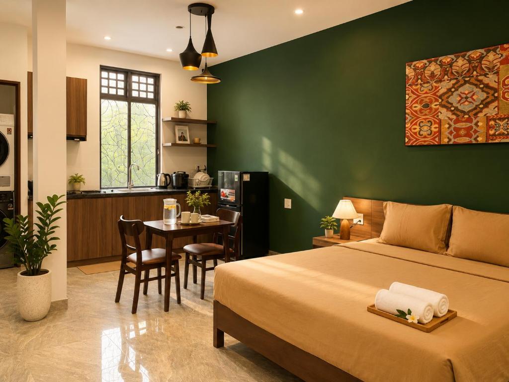 a bedroom with a bed and a kitchen with a table at Unity Villa Staycation -Self Checkin in Hoi An