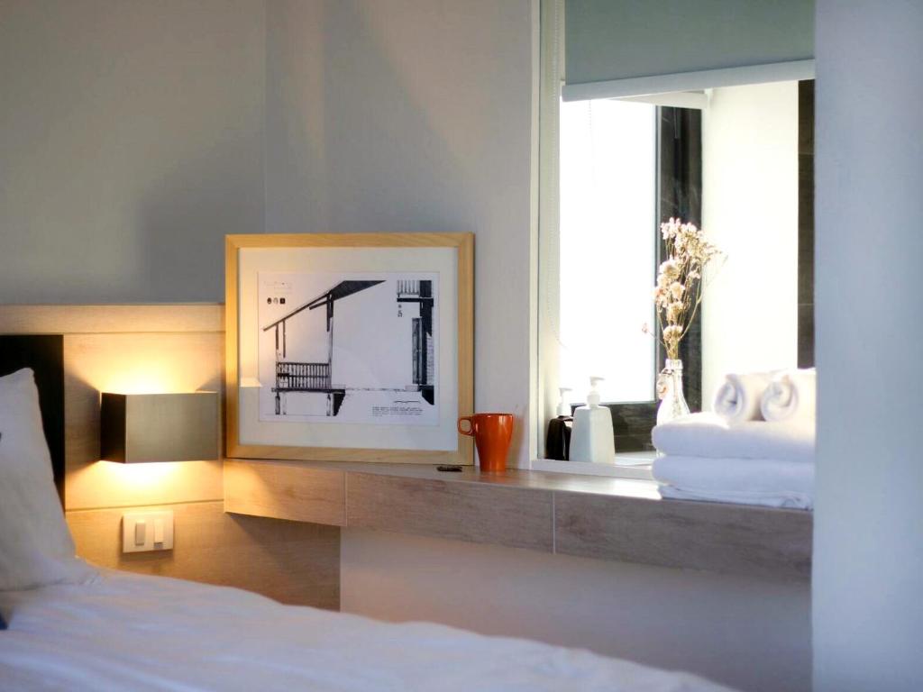 Postel nebo postele na pokoji v ubytování NornDee Hotel
