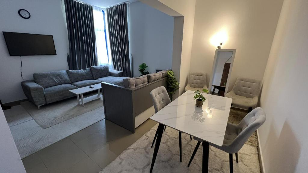 a living room with a table and a couch at Banny Homes - Cozy Suite Apartment - Downtown in Abu Dhabi