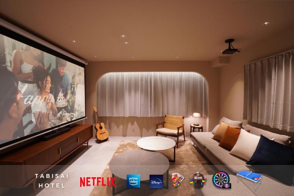 a living room with a large flat screen tv at TABISAI HOTEL Premium 博多-中洲 in Fukuoka