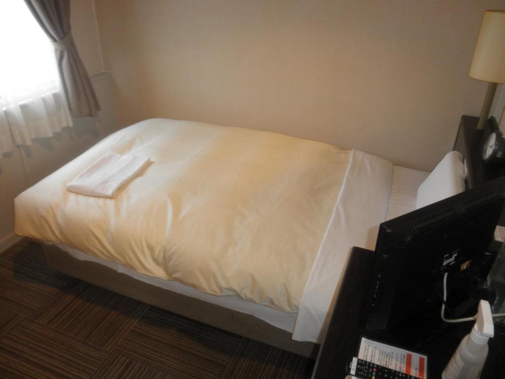 Postel nebo postele na pokoji v ubytování Hosplitality In Yawatajuku