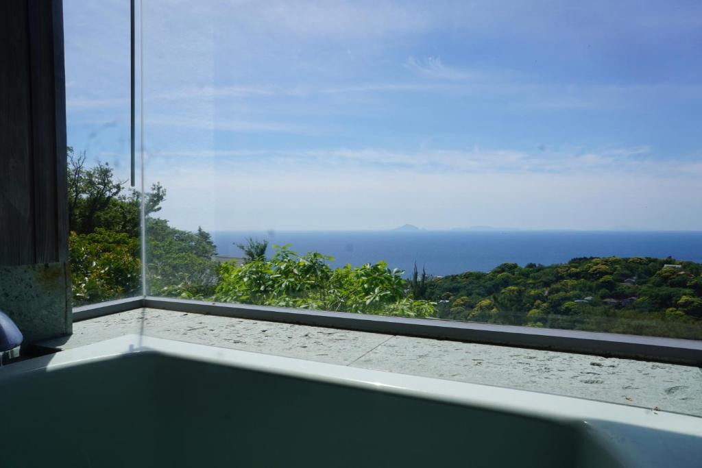 a view of the ocean from a room with a window at 海を望む東伊豆の一棟貸し ula Ocean-view private stay in Izu in Higashiizu