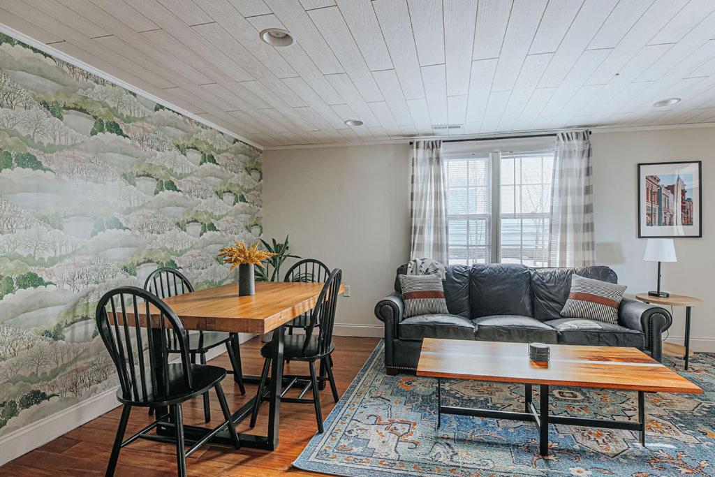 a living room with a couch and a table at The Hunker Down in Staunton