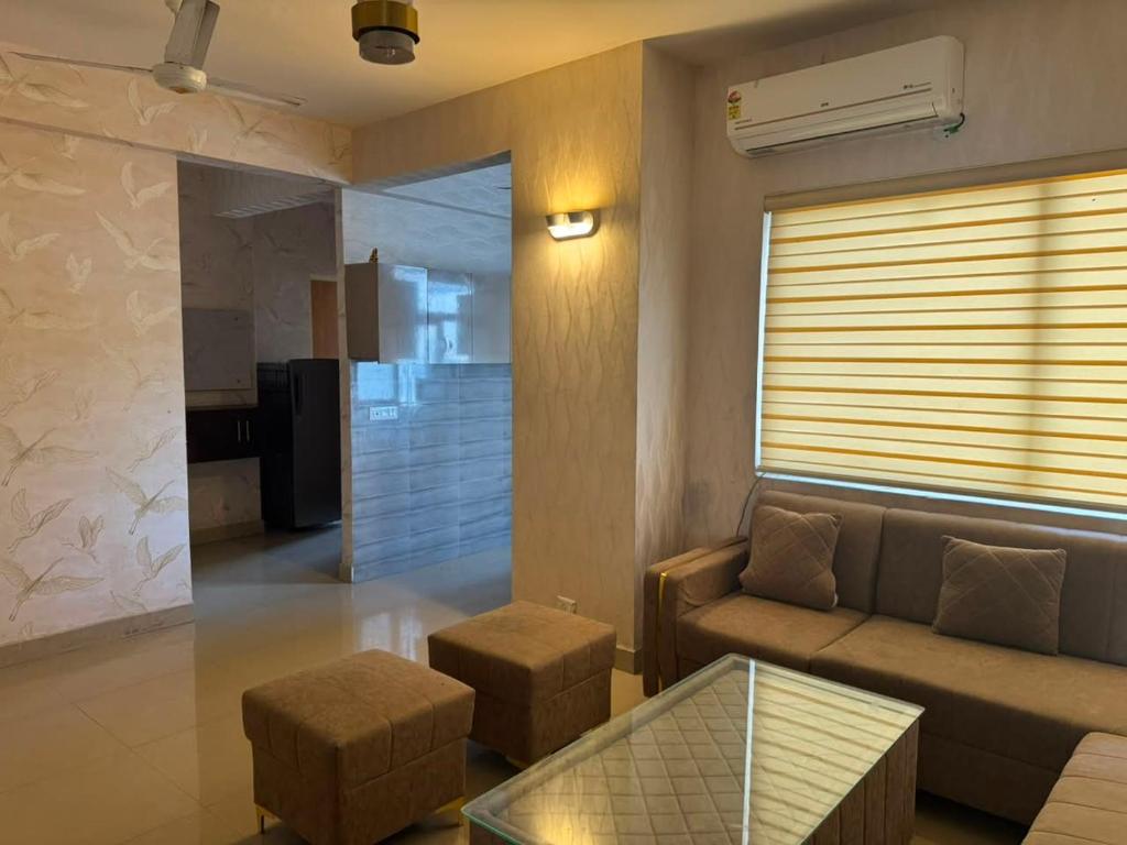 a living room with a couch and a table at Pindora Stays in Ludhiana