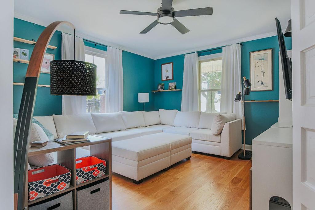 a living room with a white couch and blue walls at The Wayne Shire in Waynesboro