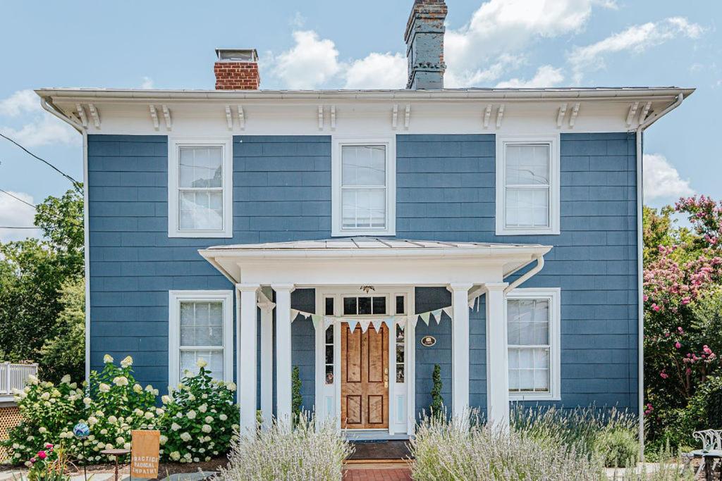 a blue house with a white front door at The Woodward in Staunton