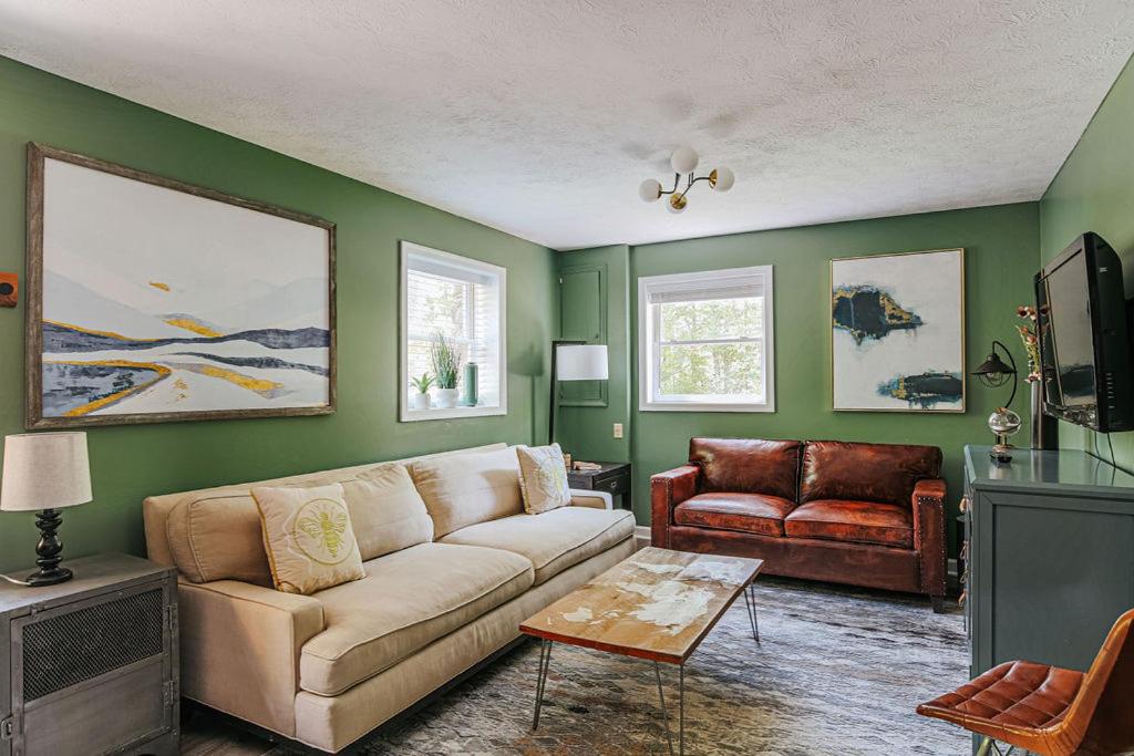 a living room with a couch and a tv at Tucked Inn: Lower Unit in Nellysford