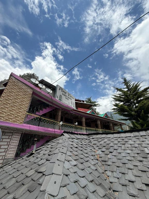 a roof of a building with a sign on it at Pine View By Wonderhill in Manīkaran