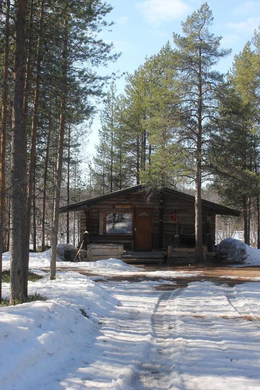 a small cabin in the woods in the snow at River cabin Tapio in Inari