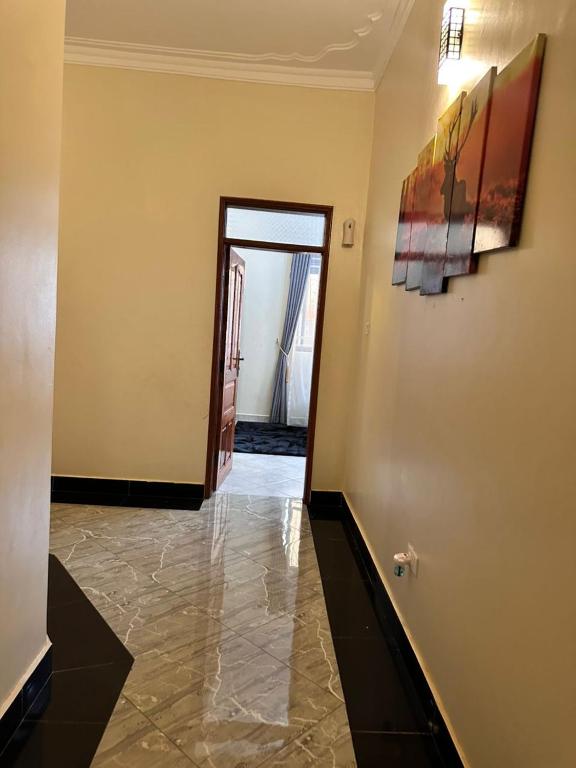 a room with a hallway with a painting on the wall at GRACE ViLLA in Kitende