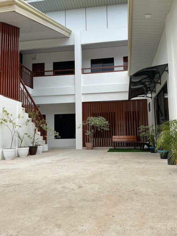 an empty courtyard of a building with potted plants at SabinaGateway Suites in Panglao Island