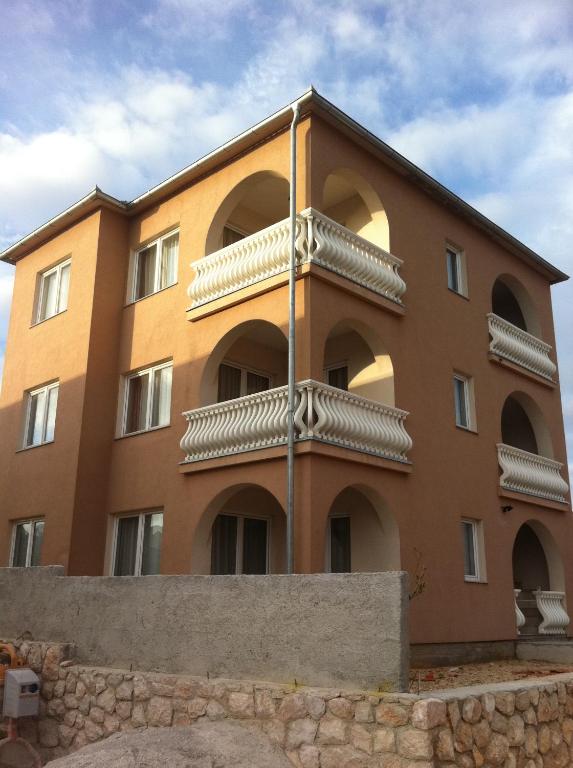 a building with balconies on the side of it at Apartments Mara in Novi Vinodolski