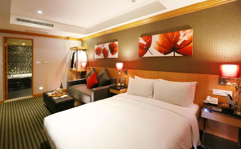 a hotel room with a bed and a couch at Beauty Hotels Taipei - Hotel Bchic in Taipei